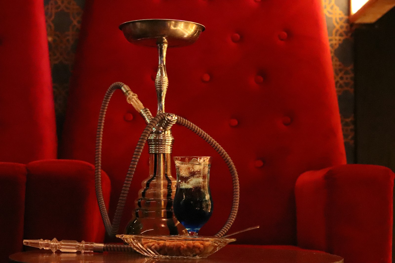 Ambient Atlanta hookah lounge with a lit shisha pipe on the table, illustrating the smoking, tobacco, and late-night exposures that make hookah bars a distinct insurance risk