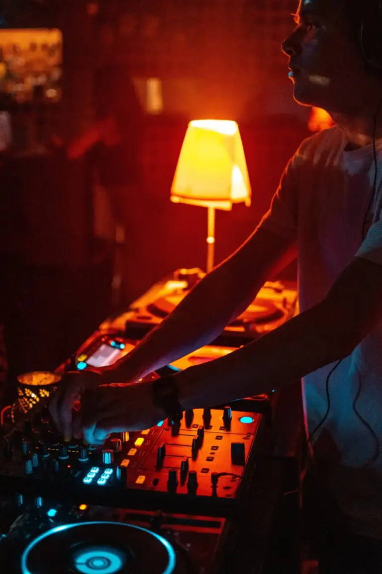 DJ performing at a dimly lit nightclub with turntables and mixer, illustrating high-risk late-night venue exposures