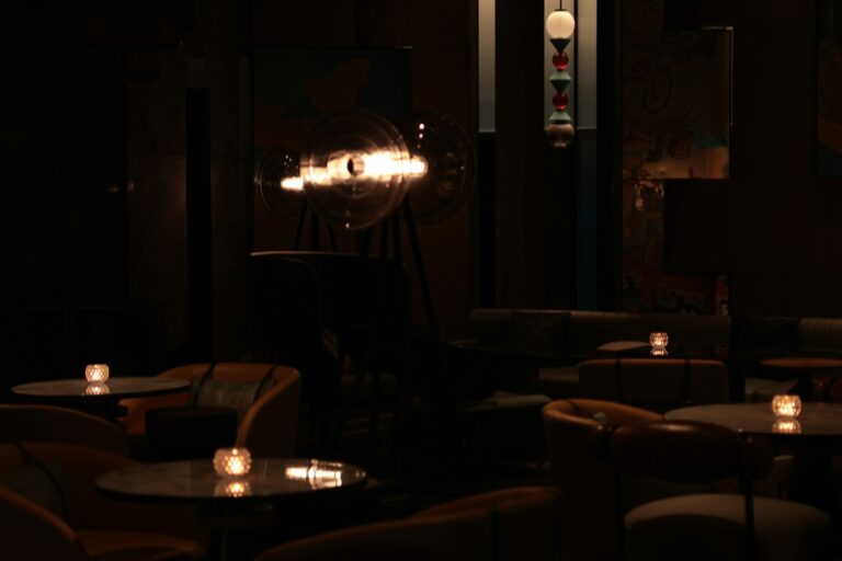 Dimly lit Atlanta restaurant bar interior with empty tables and candlelight, illustrating the coverage gaps that catch restaurants and clubs before opening