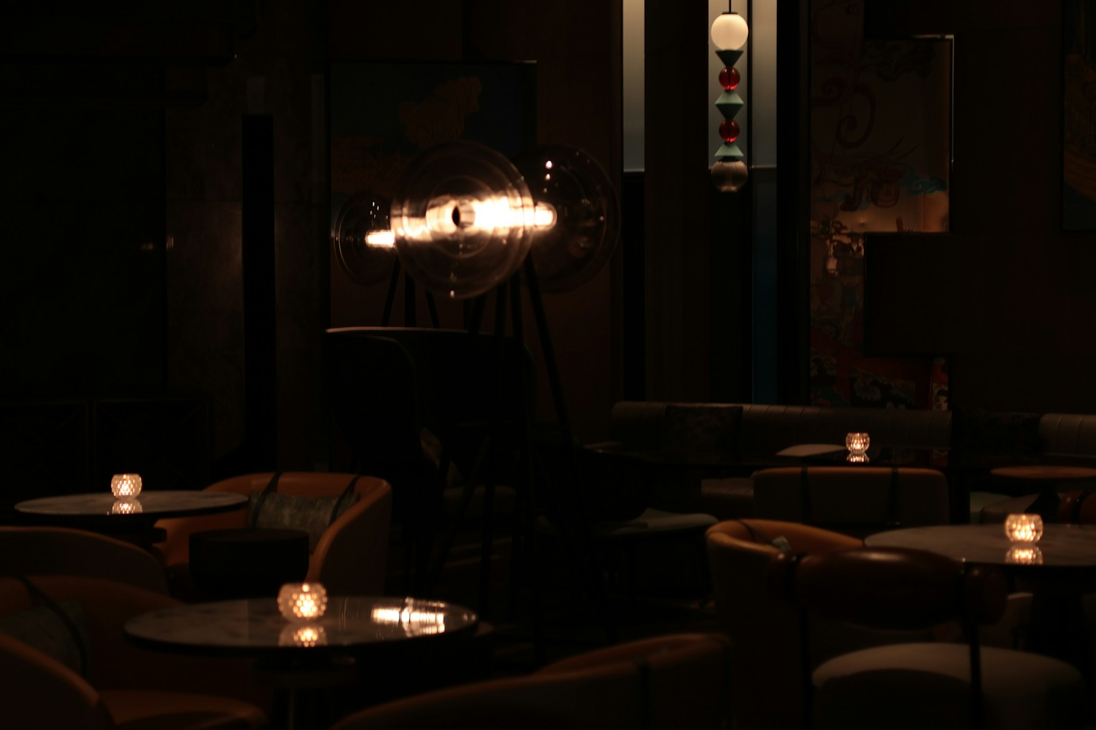 Dimly lit Atlanta restaurant bar interior with empty tables and candlelight, illustrating the coverage gaps that catch restaurants and clubs before opening