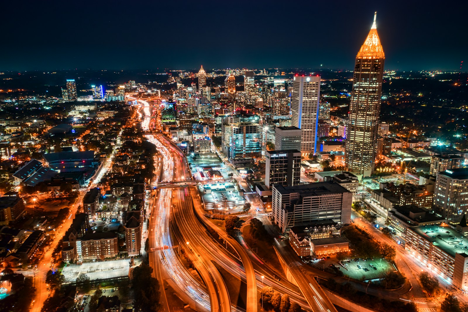 The downtown Atlanta skyline lit up at night, illustrating the citywide nightlife economy of bars, clubs, and hookah lounges whose insurance costs are shaped by Georgia's litigation and dram shop climate