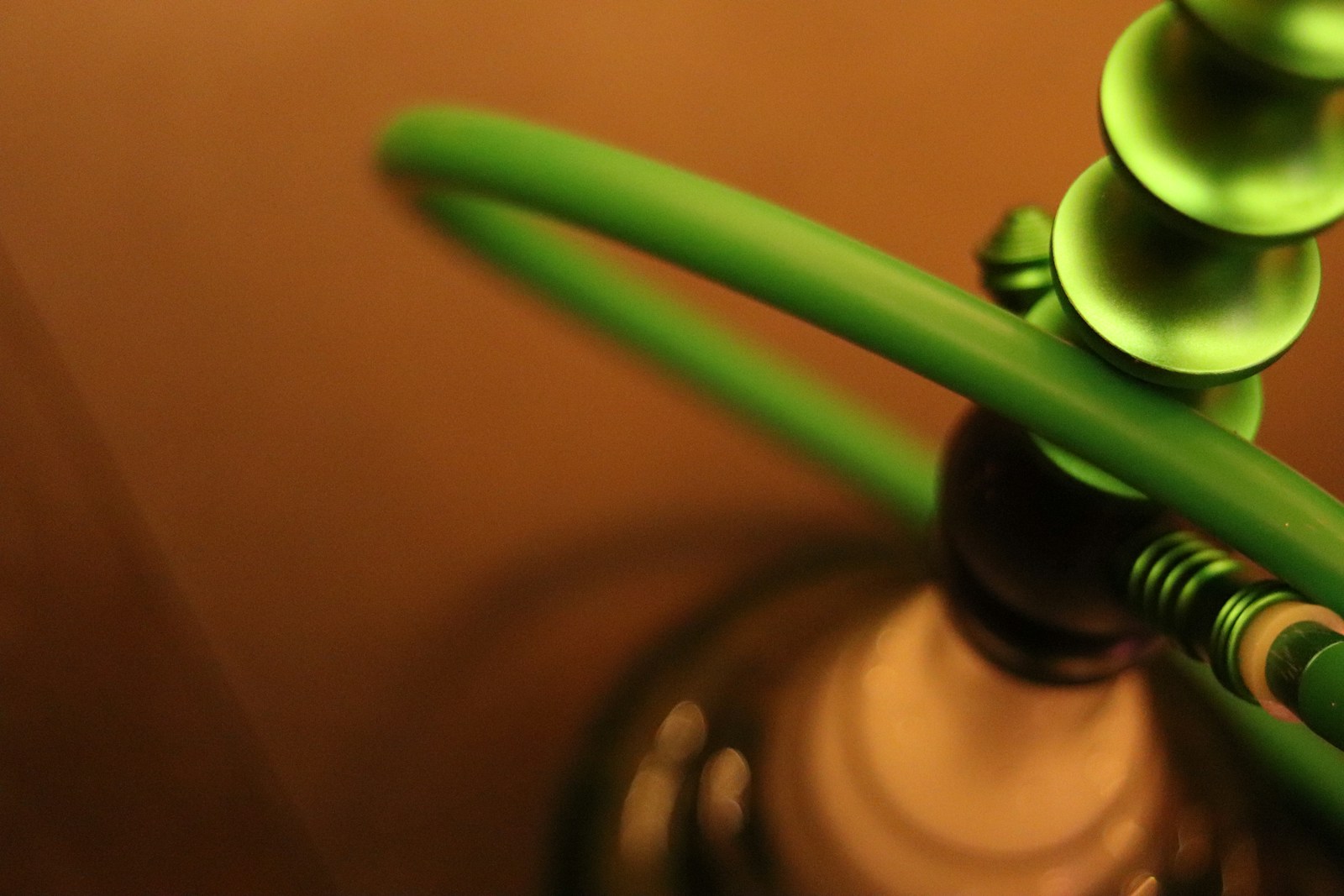 Close-up of a hookah with a glowing lit coal in a dim Atlanta lounge, illustrating the open-flame burn exposure that stacks on top of assault and battery risk in the city's hookah bars