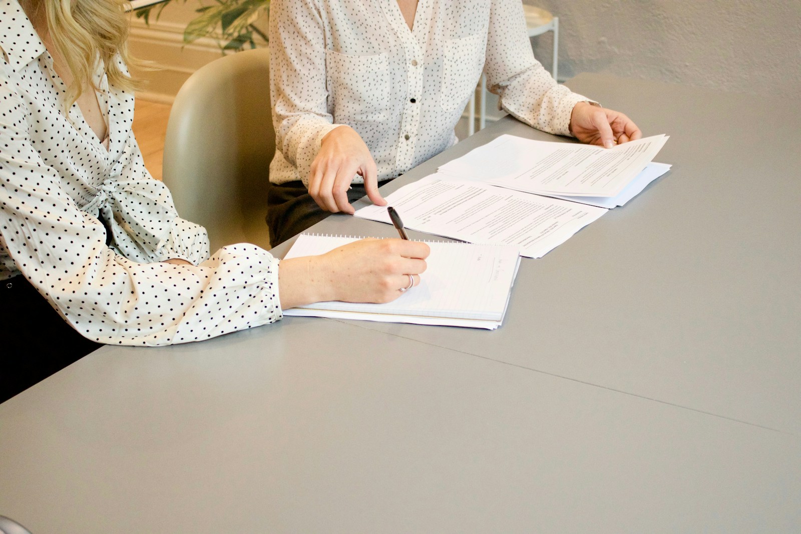 A condo buyer carefully reading the HOA master policy declarations page and association documents before writing a purchase offer