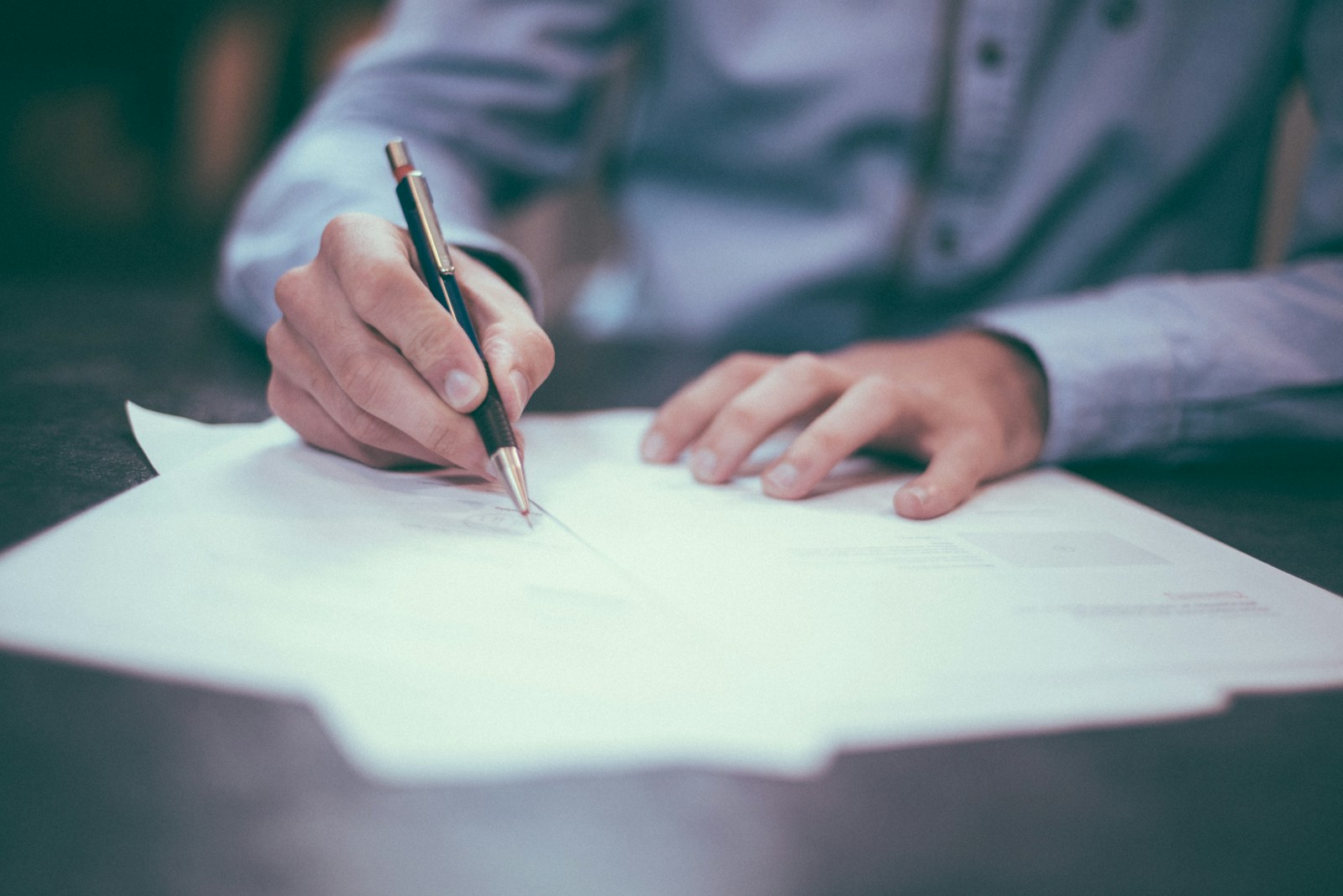 A buyer reviewing condo master insurance policy documents before signing, checking the per-unit deductible and replacement cost coverage