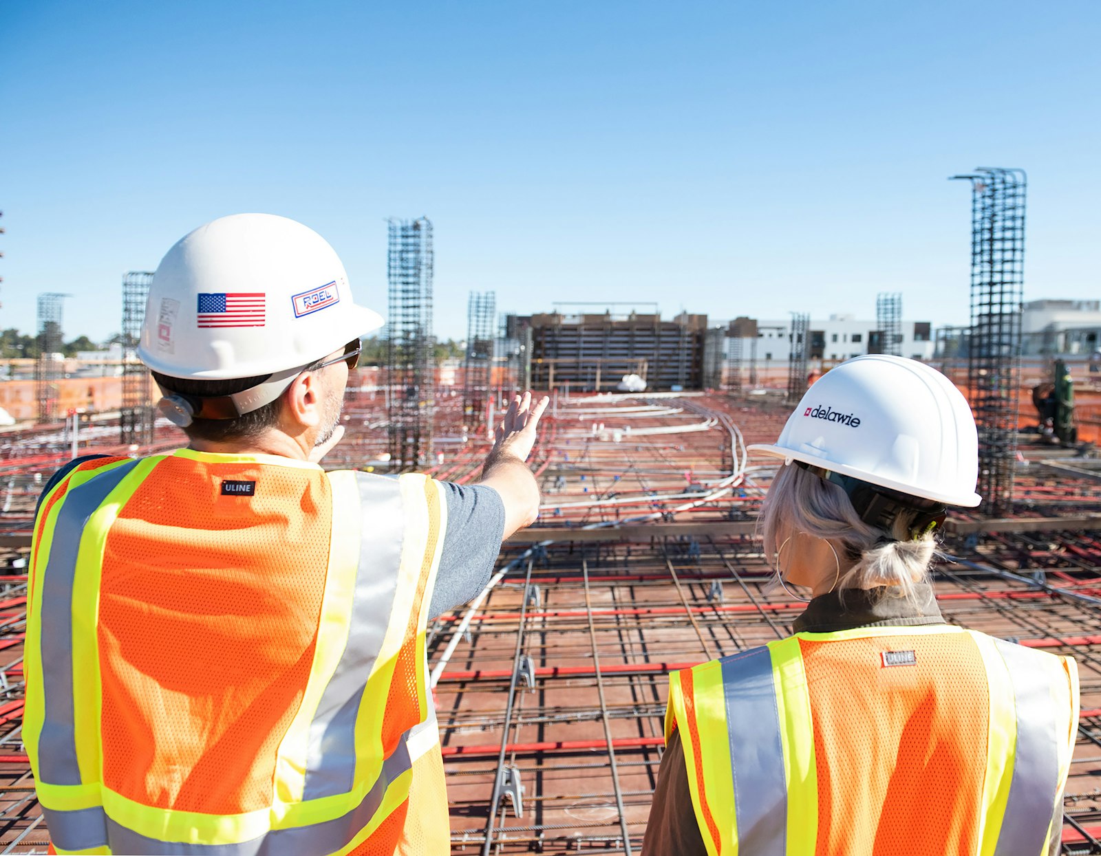 Two Georgia construction workers in safety vests on a job site