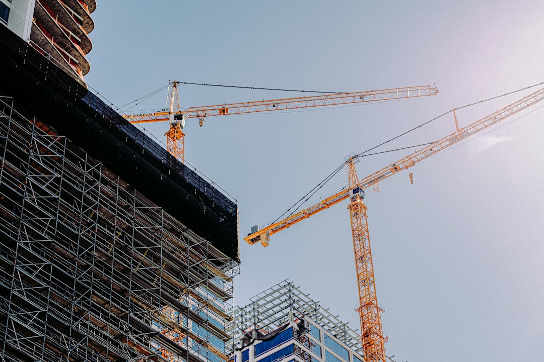 Large commercial building under construction with cranes, the kind of project where general contractors enforce strict insurance requirements