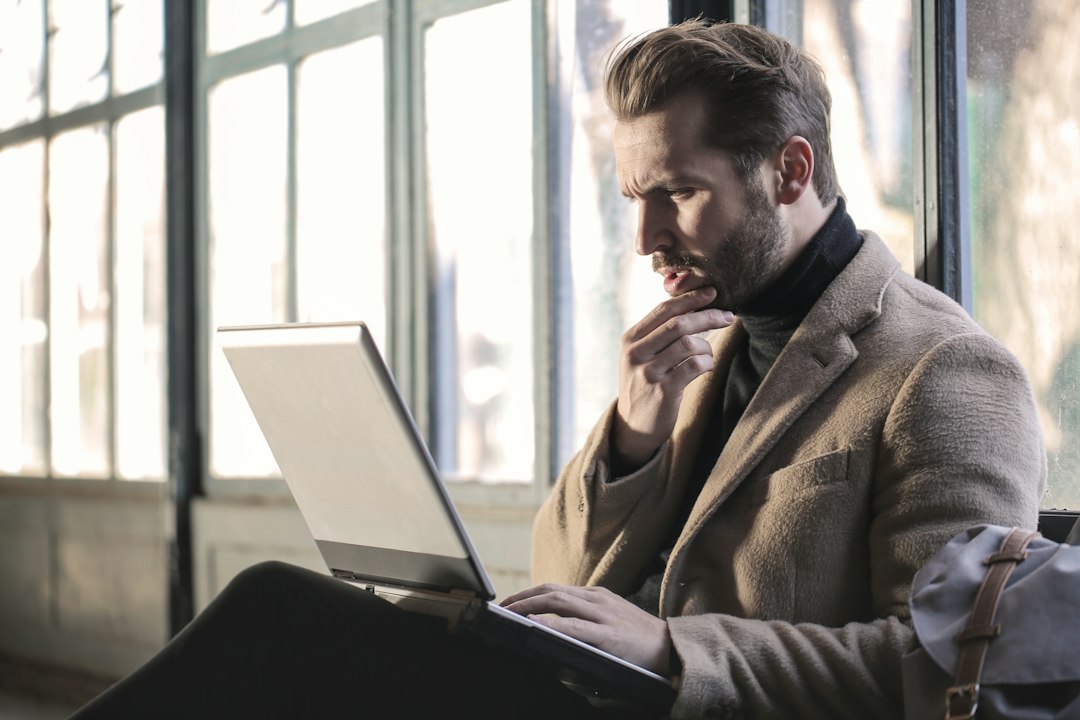 Stressed professional at a laptop after receiving a client complaint