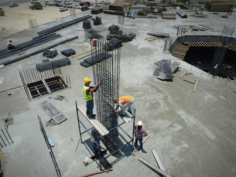 Contractor crew and general contractor meeting on an active construction site before work begins
