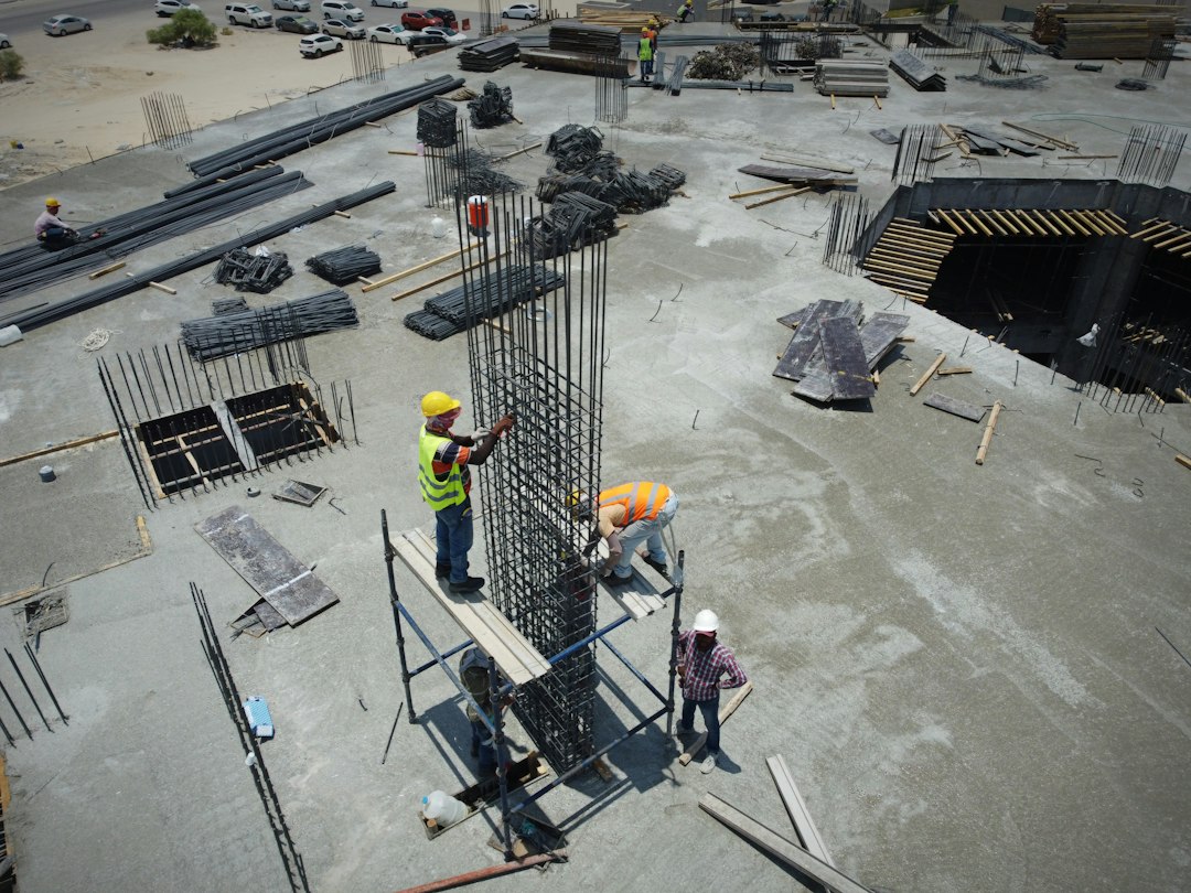 Contractor crew and general contractor meeting on an active construction site before work begins