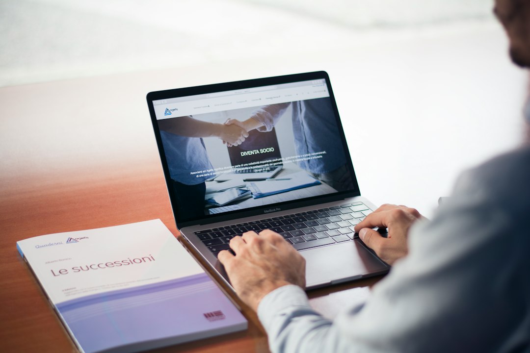 Professional's hands typing on a laptop, representing everyday business use of AI tools