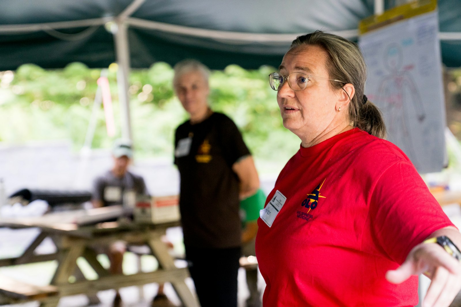 Volunteer board member speaking to a community group outdoors