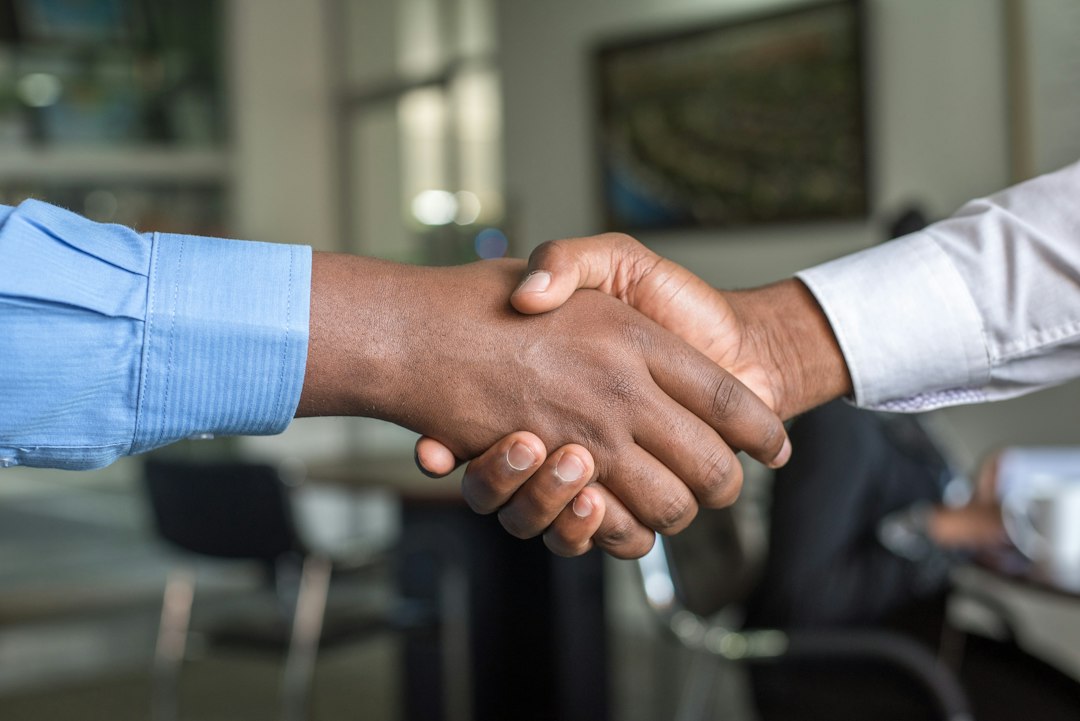 Business owner shaking hands with an insurance broker after securing replacement coverage before the policy expired