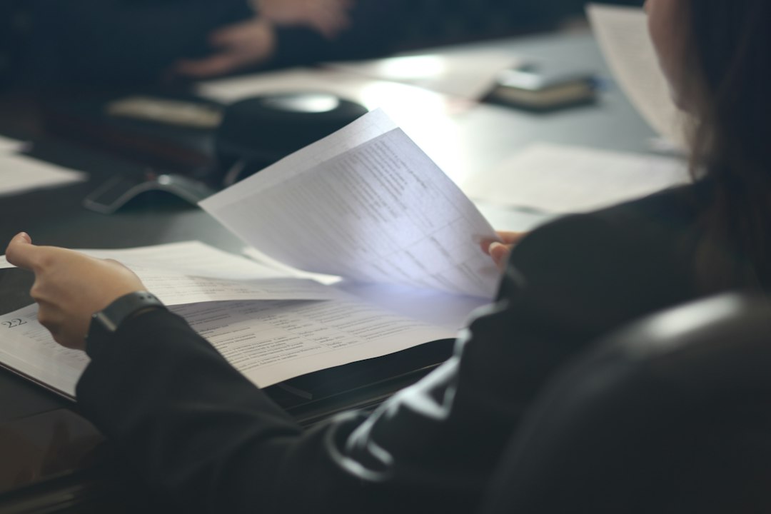Board member reading through an association insurance policy at a table